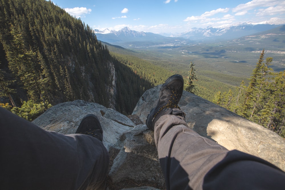 a person standing on top of a large rock