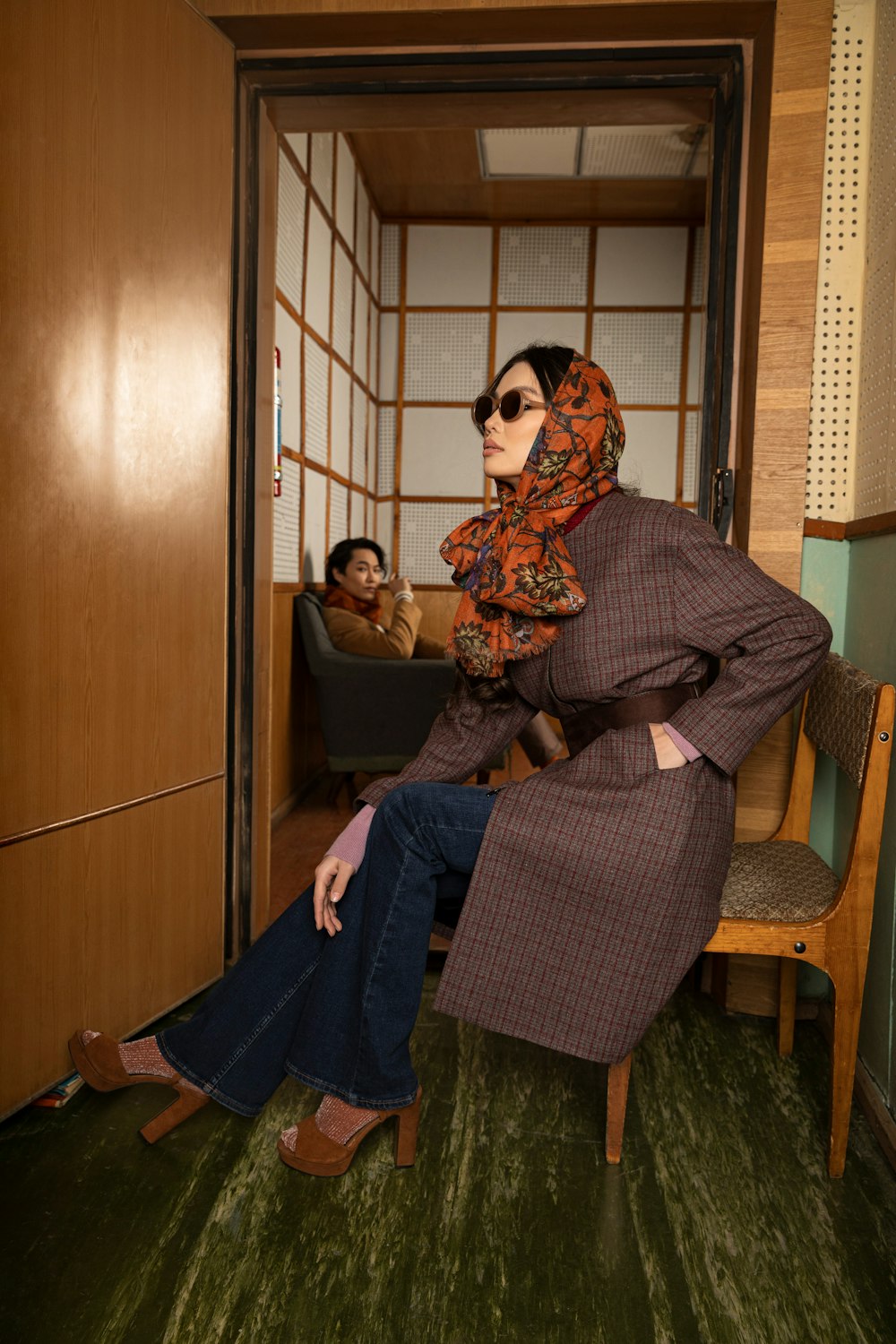 woman in brown and black hijab sitting on black armchair