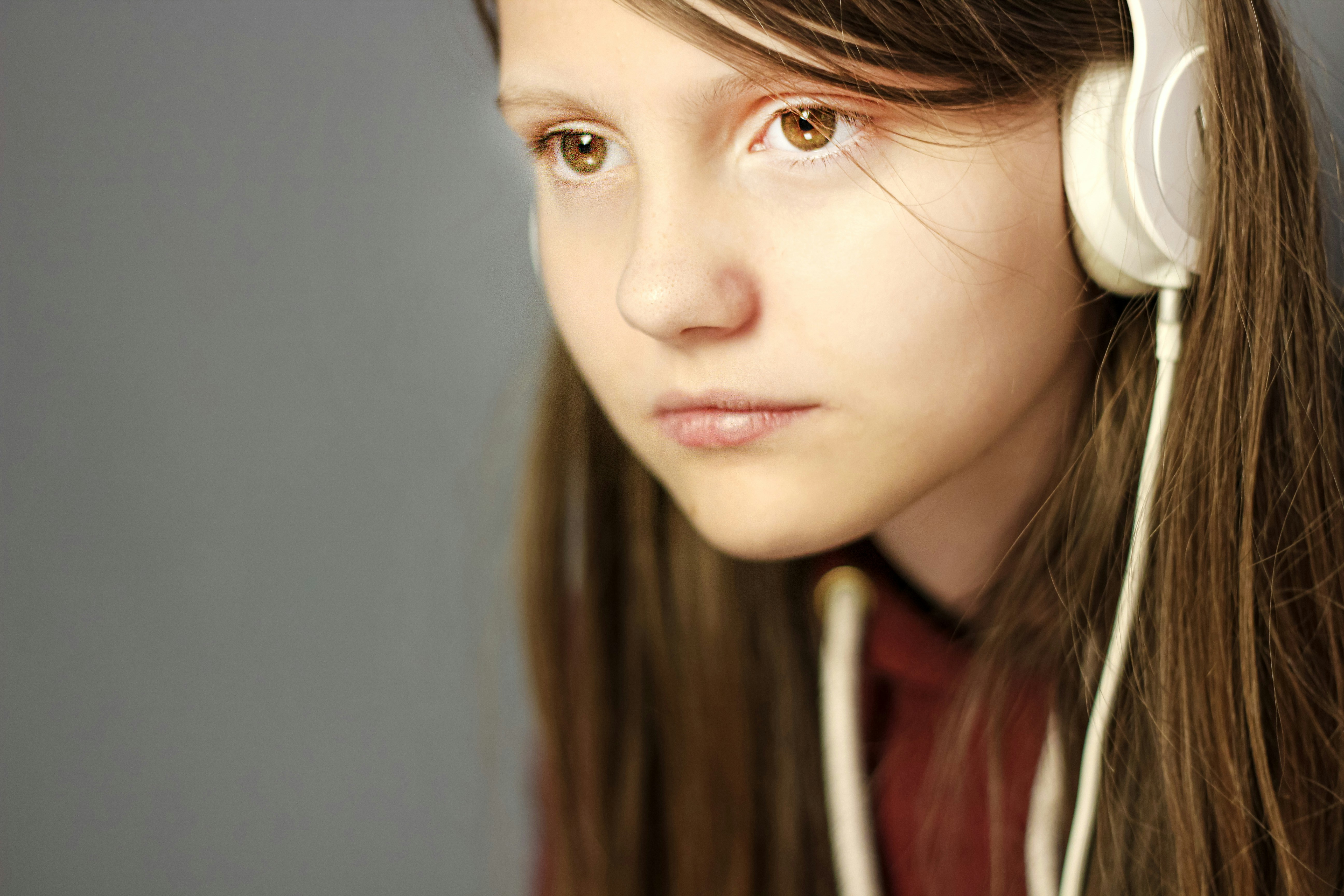 Woman with thoughtful expression, music listening photo