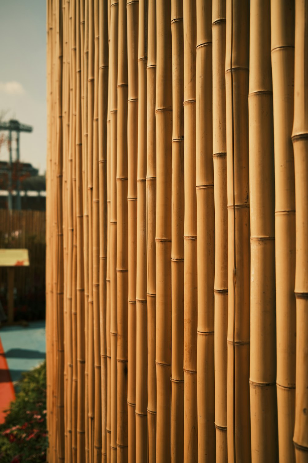 brown wooden post near red and white house during daytime