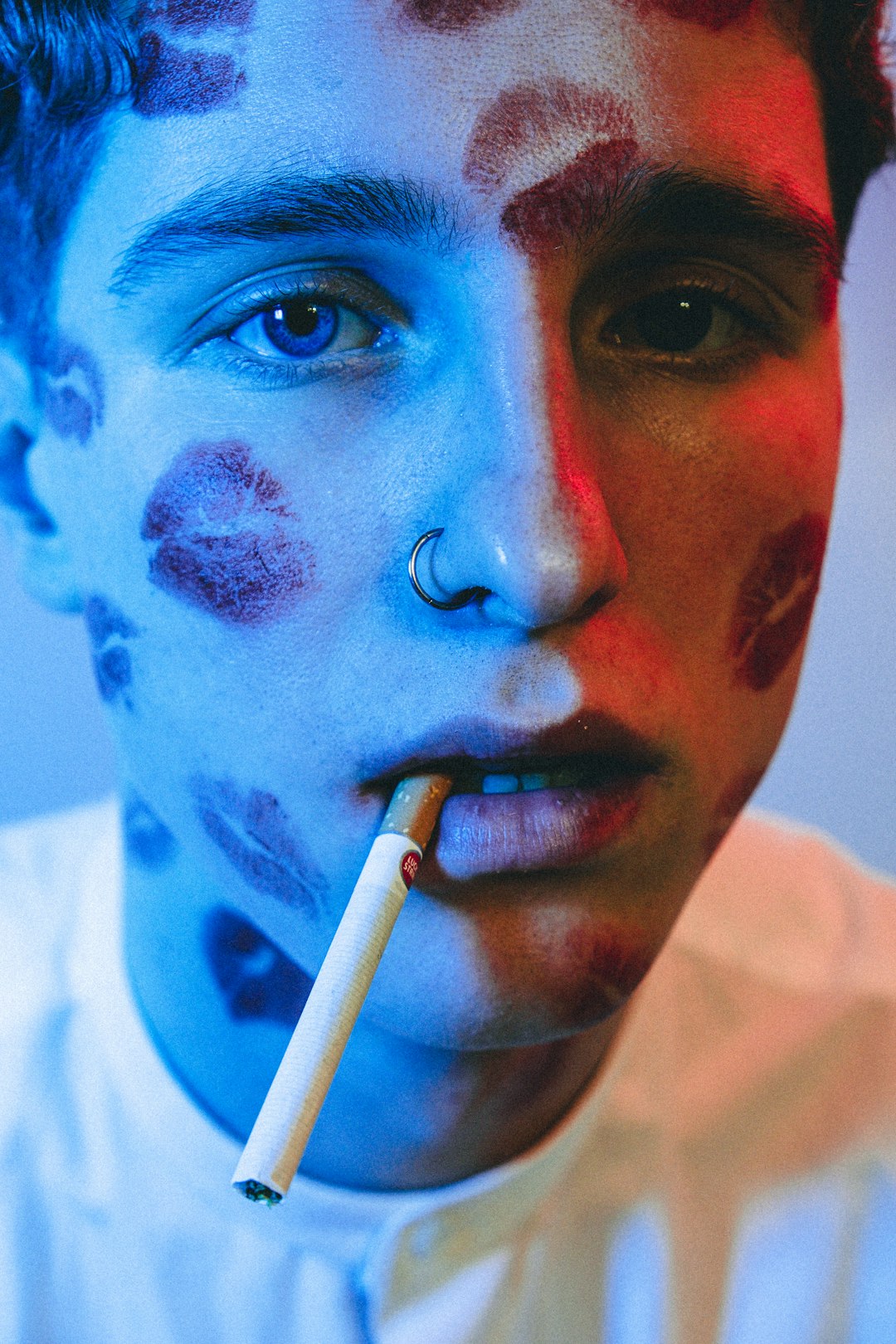 man in white crew neck shirt with blue and white paint on face