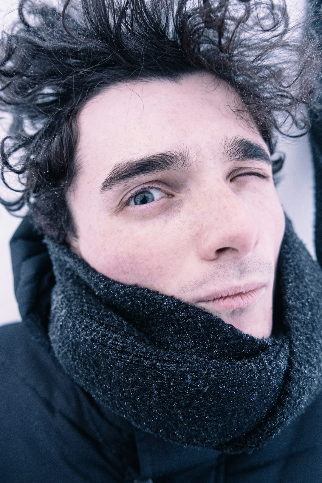 man in black scarf and blue jacket