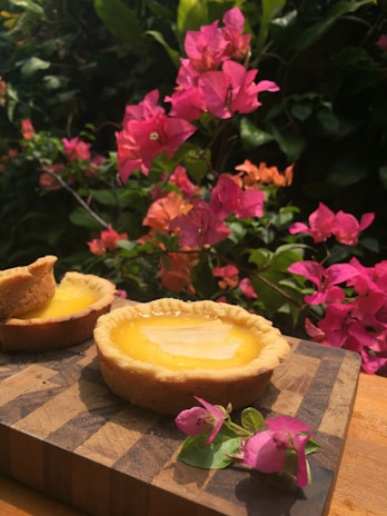 A close-up of delicious lemon tarts arranged on a wooden table.