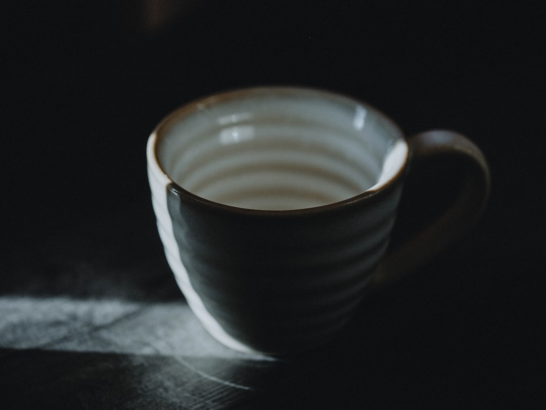 white and blue ceramic mug