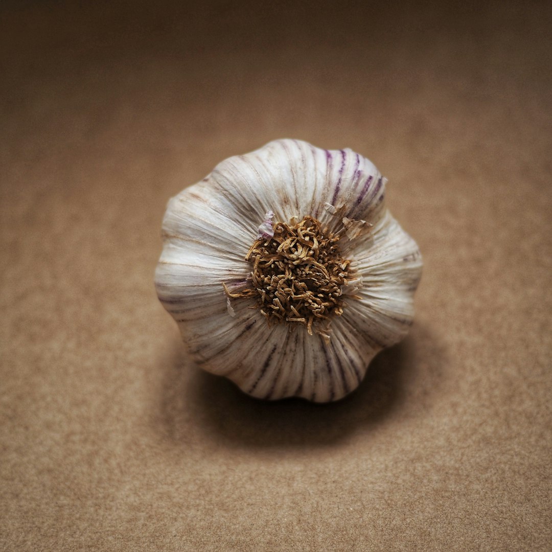white garlic on brown surface