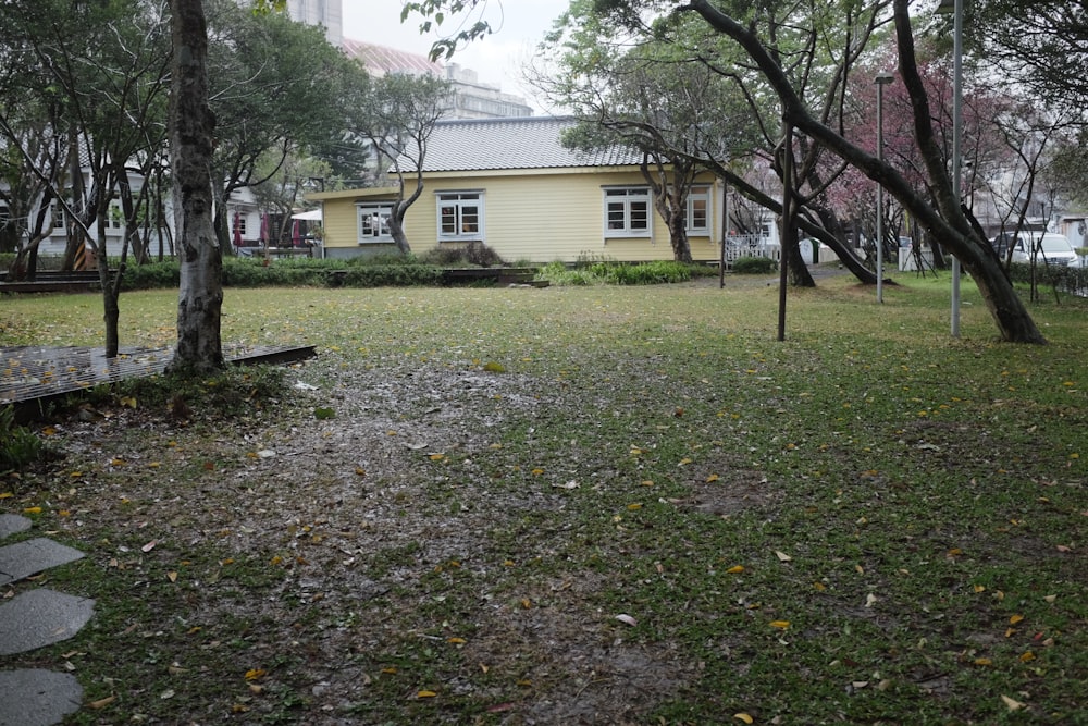 white and brown house near green trees during daytime