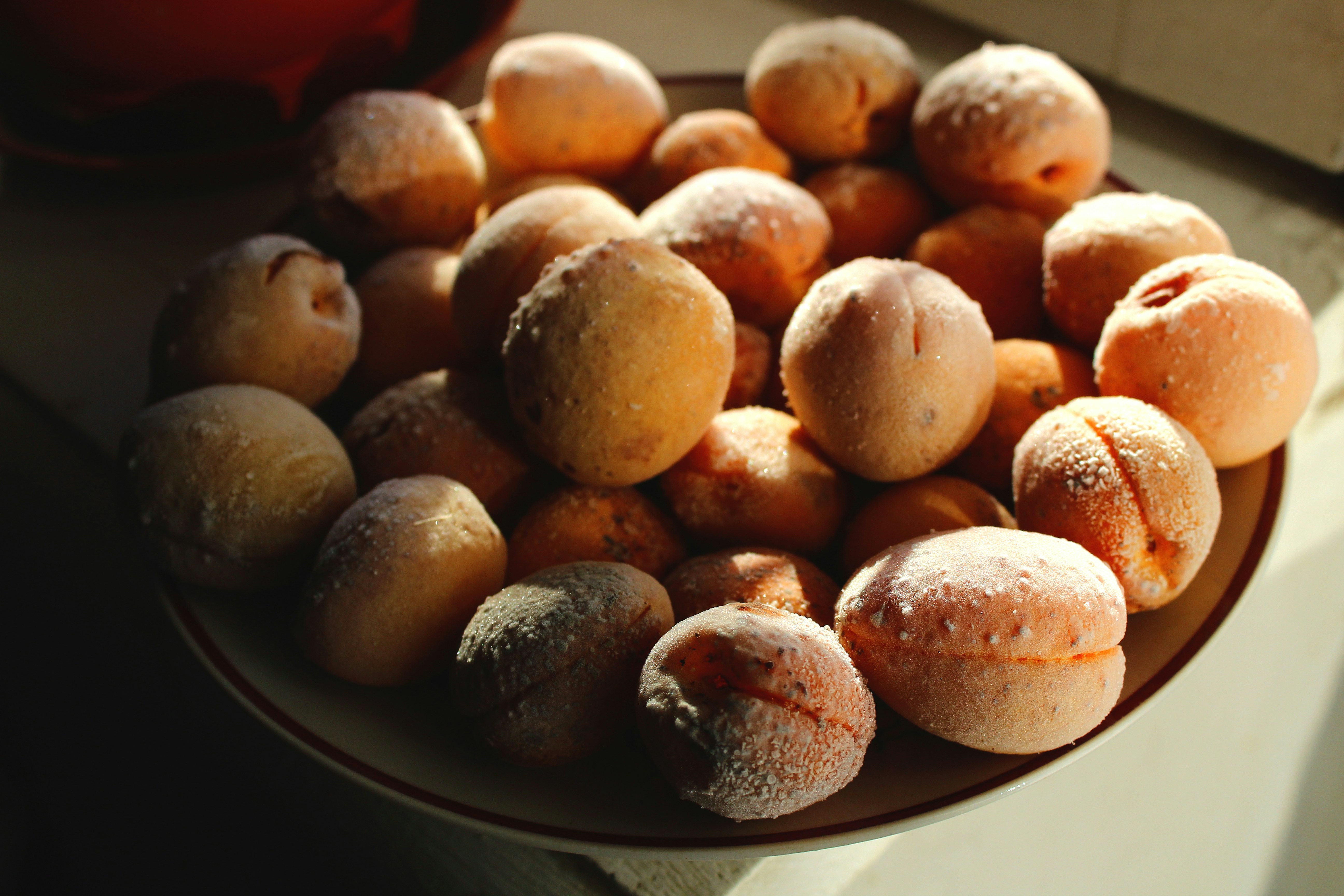 brown round fruit on black ceramic plate