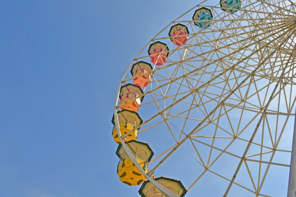 white and red ferris wheel under blue sky during daytime