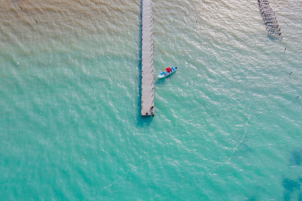 aerial view of 2 person riding on boat on sea during daytime