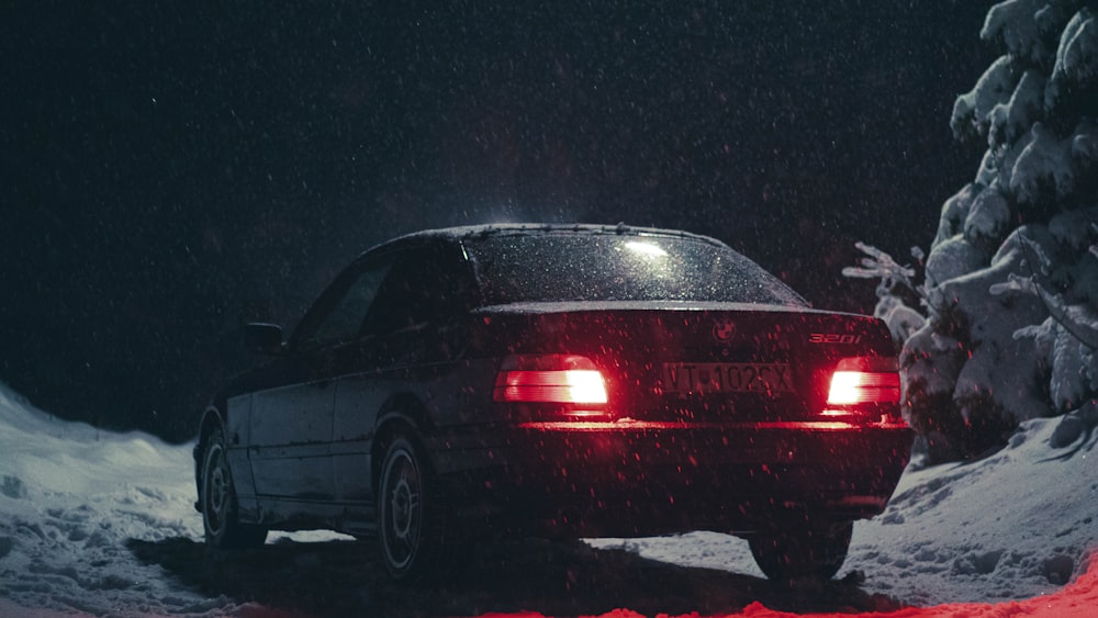 red sedan on black asphalt road