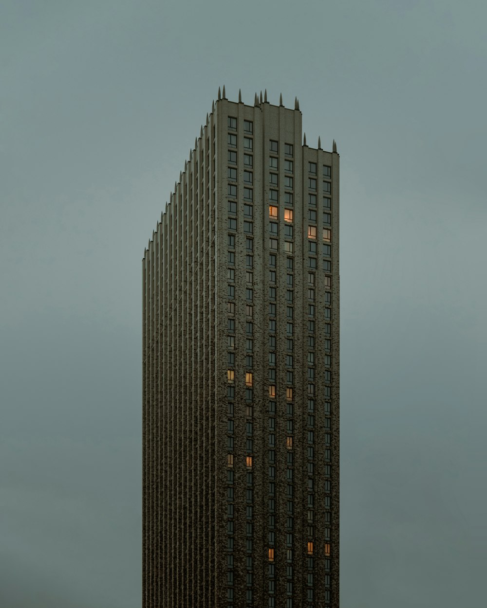 black high rise building under gray sky