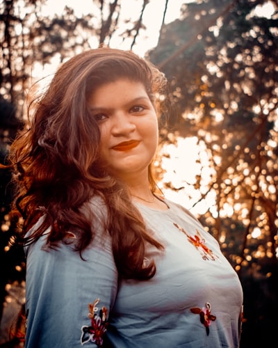 Indian woman smiling in a white shirt outdoors