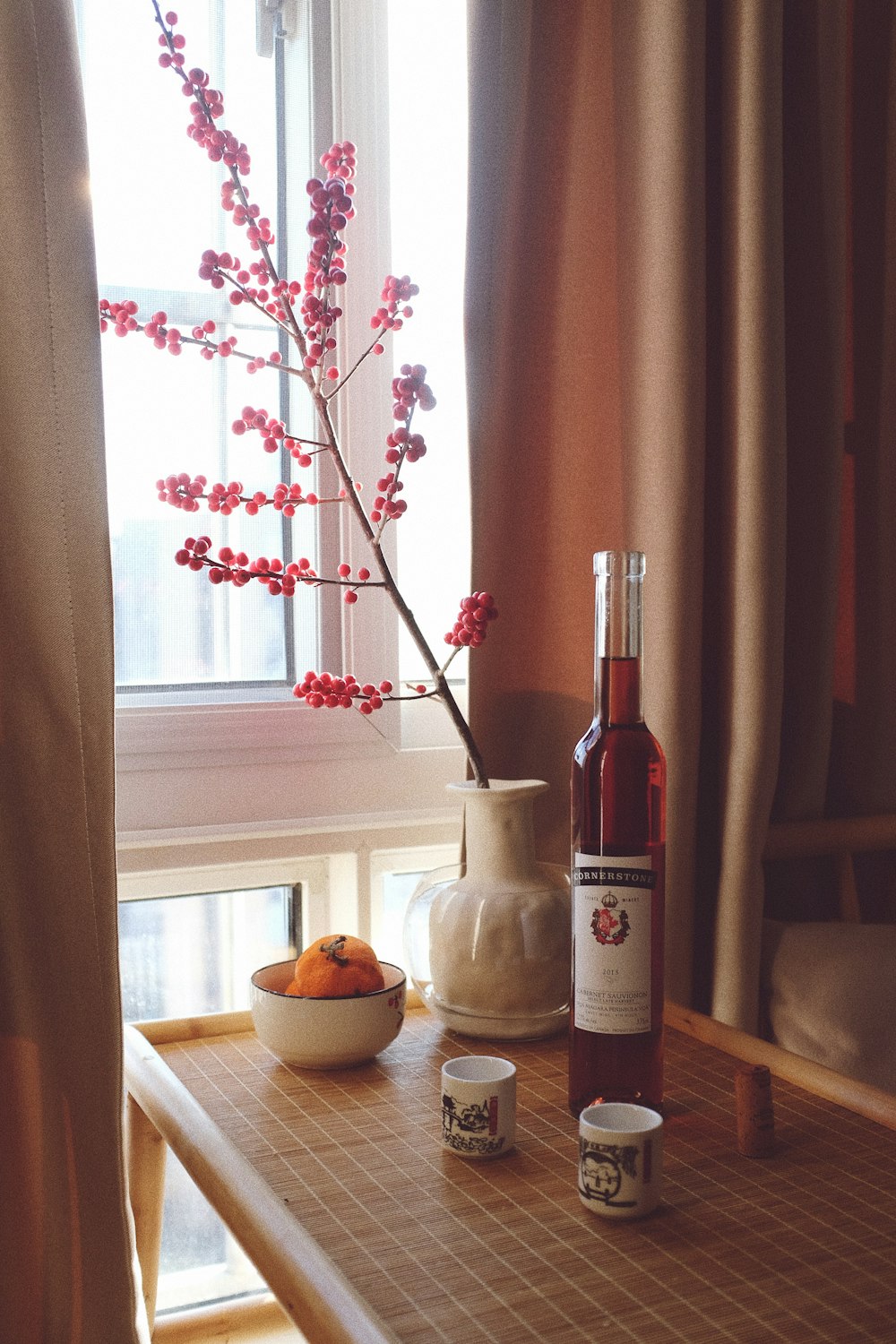 clear glass bottle on brown wooden table