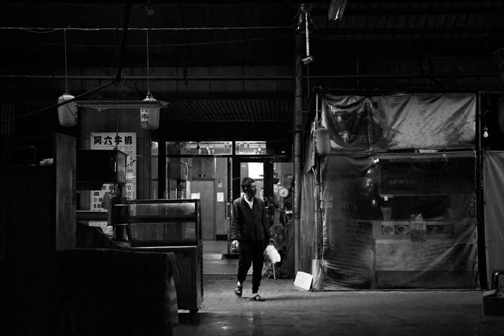 grayscale photo of people walking on sidewalk