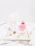 Soft ivory marble countertop with gold accents holding the Sublime Fresh Face Set and a lit candle.