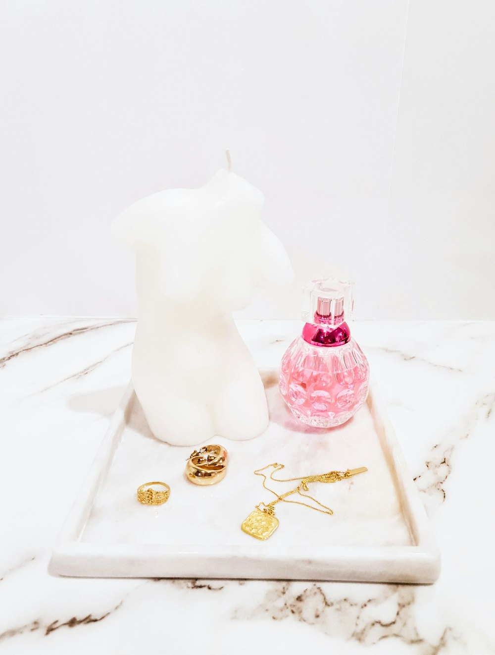 white ceramic cat figurine on white and gold floral tray