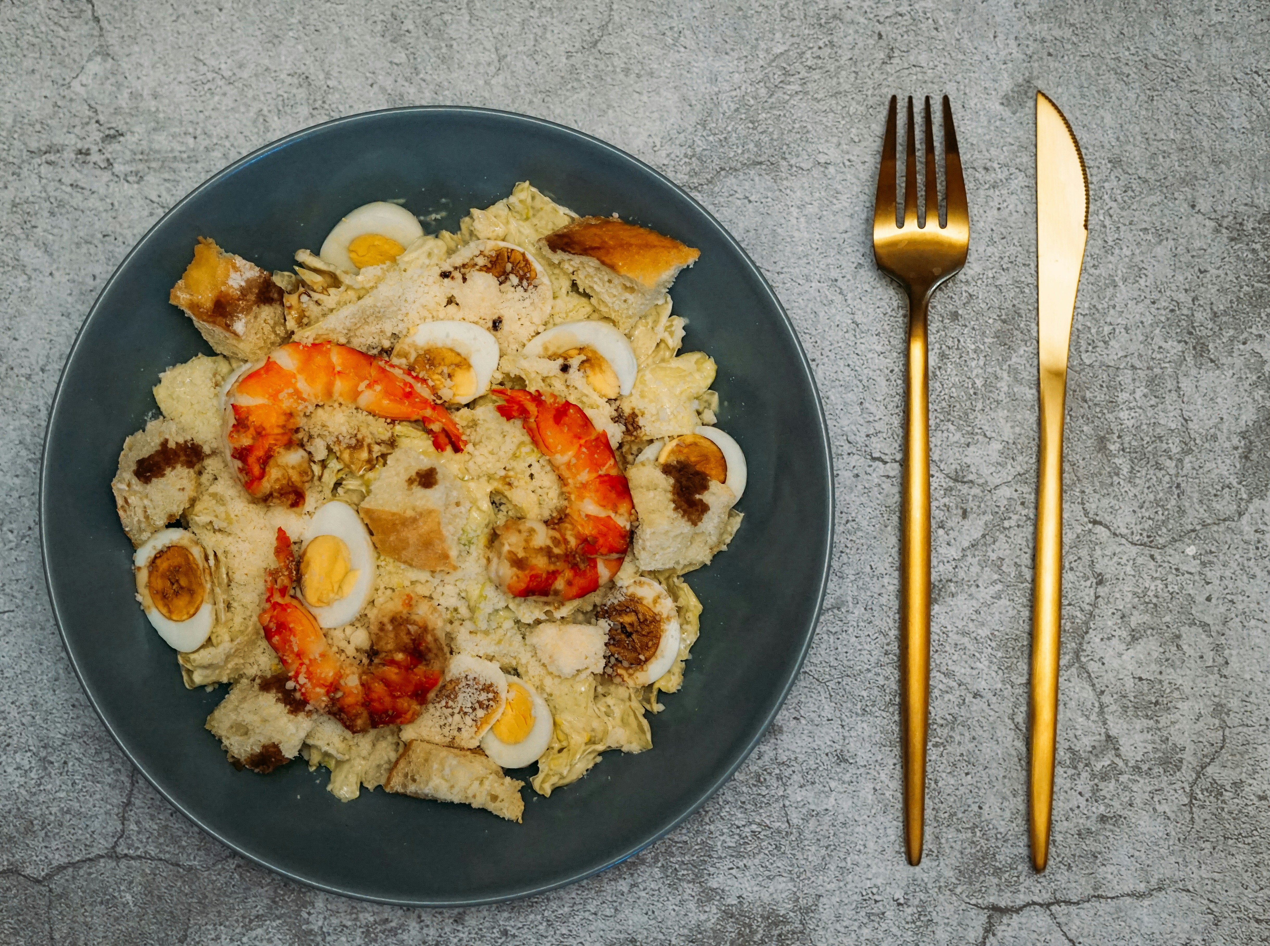 stainless steel fork and knife on black ceramic plate