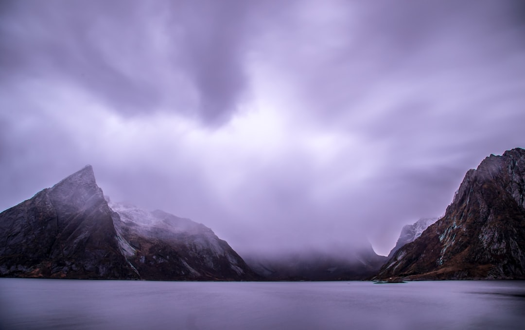 snow covered mountain under cloudy sky