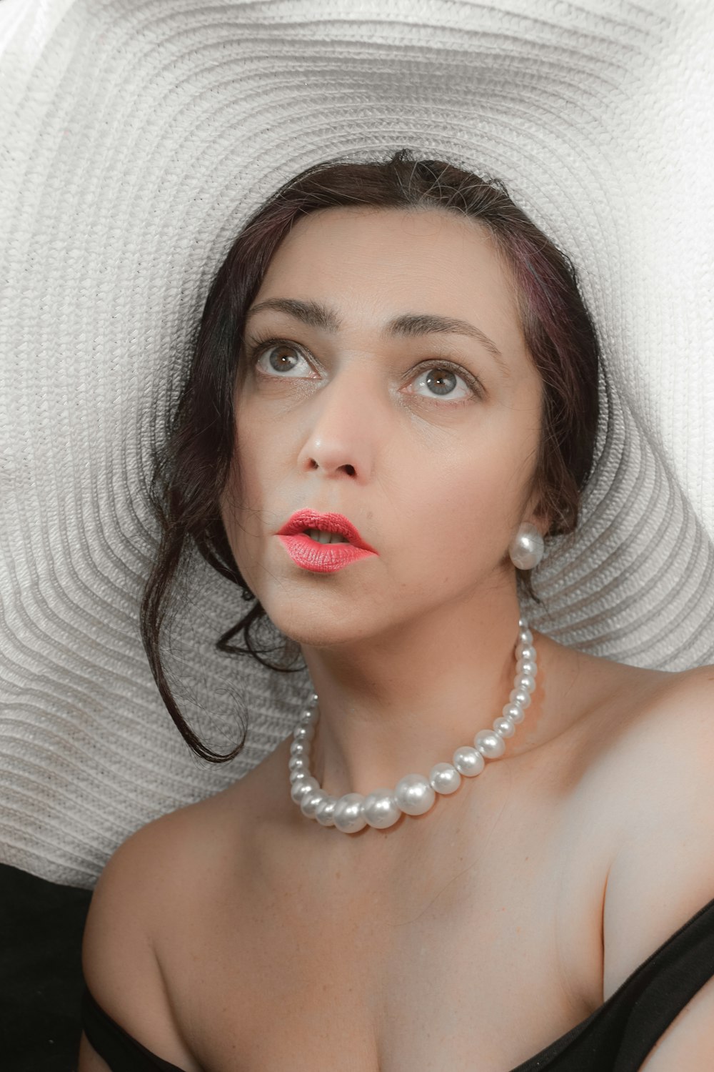 woman in white pearl necklace