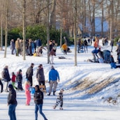 A vibrant scene of tourists enjoying the beauty of Gulmarg during winter.