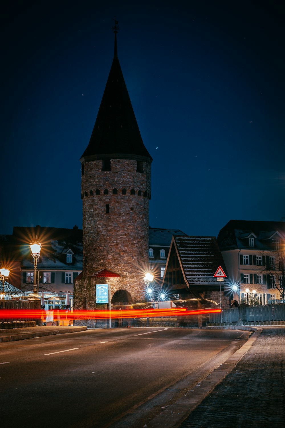 time lapse photography of cars on road near brown concrete building during nighttime