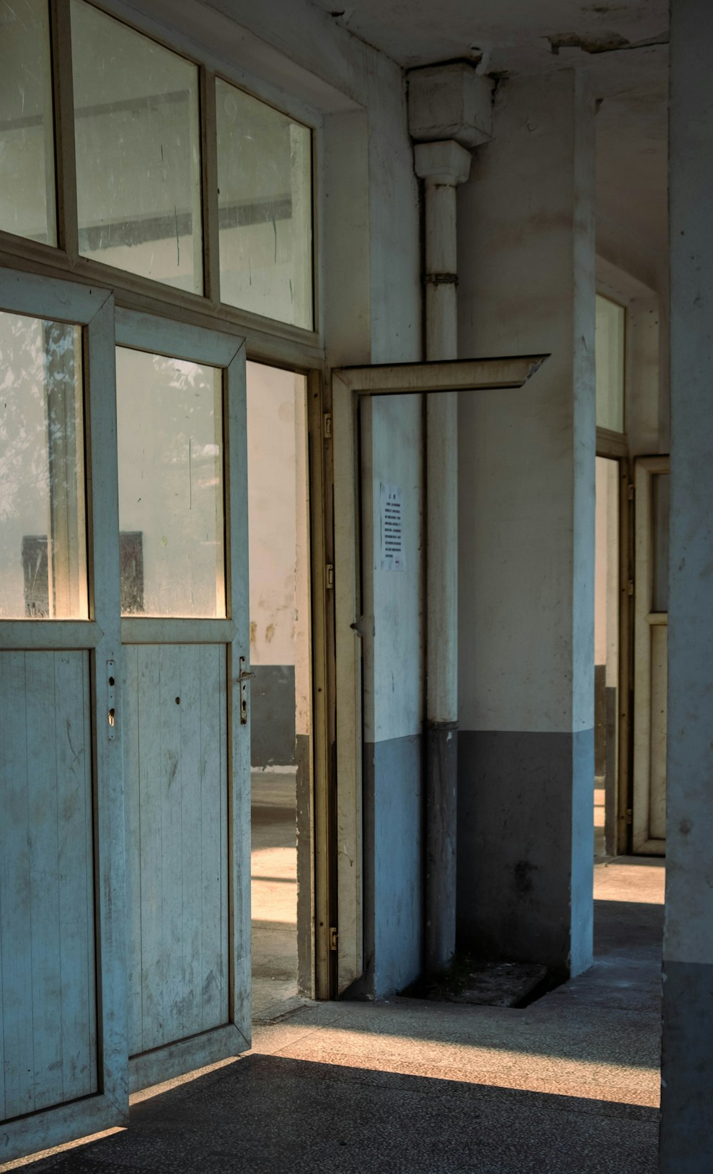 blue wooden door with glass panel