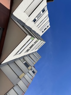 Wide shot of a modern building being painted by professionals.