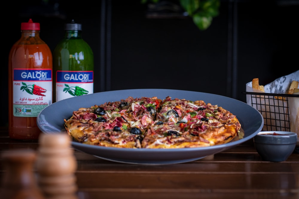 pizza with green and white sauce on white ceramic plate