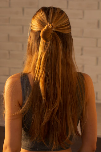 woman in black tank top with brown hair tie