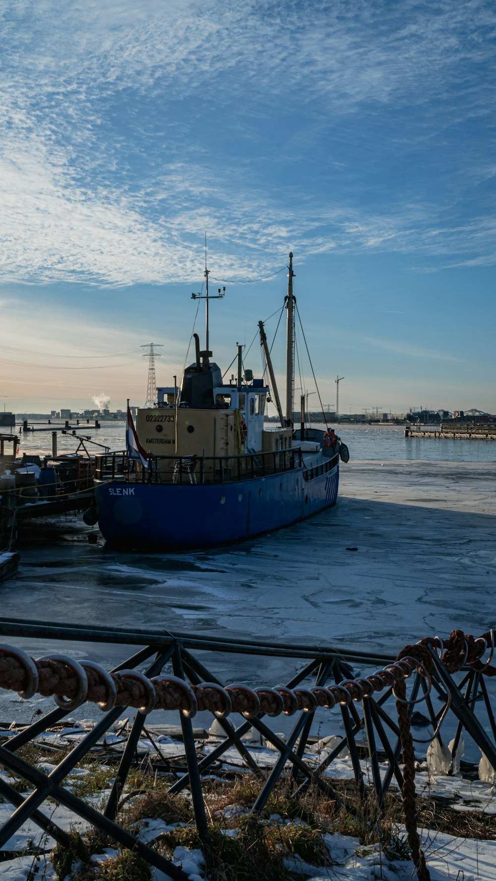 blue and white boat on sea shore during daytime