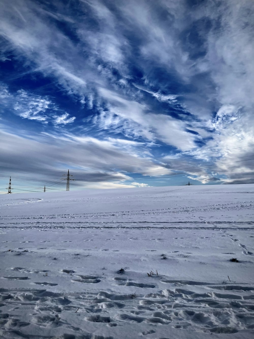 snow covered field under blue sky during daytime