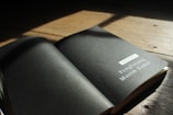 An open book from the Simply Essential series resting on a rustic wooden surface.