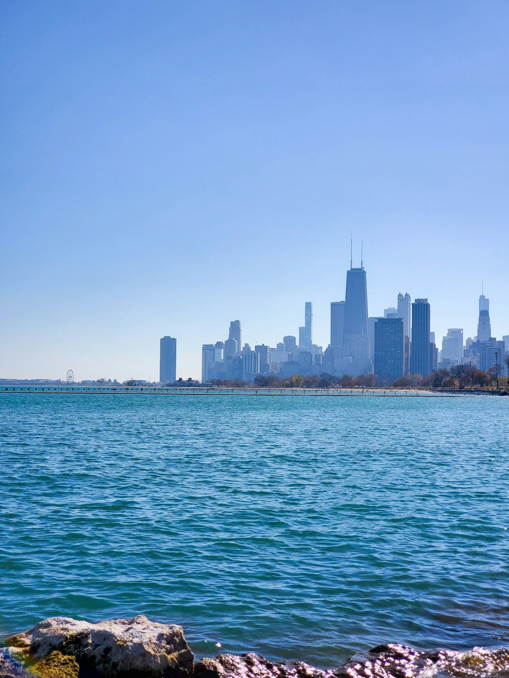 city skyline across body of water during daytime