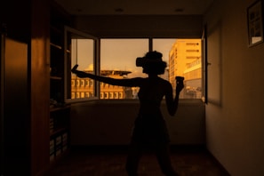 silhouette of man standing near window