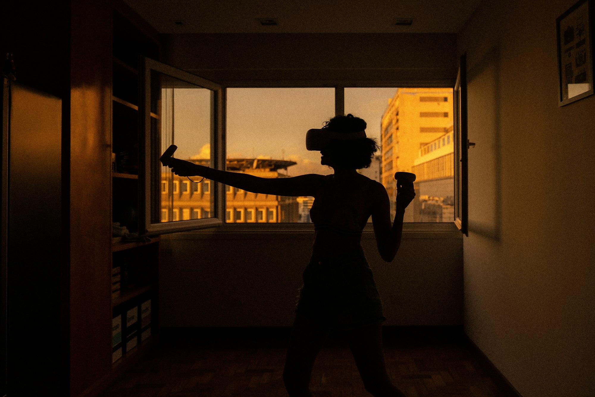 girl playing vr gaming at sunset