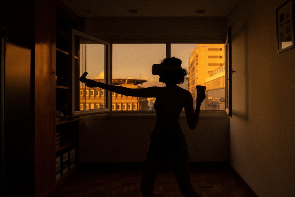 silhouette of man standing near window