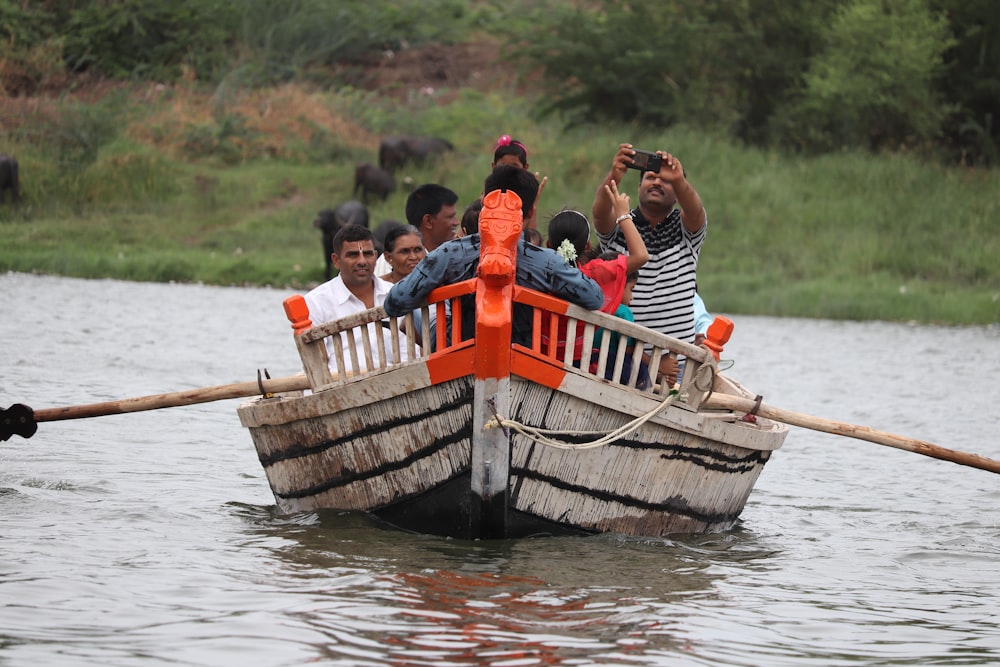 people riding on boat on river during daytime