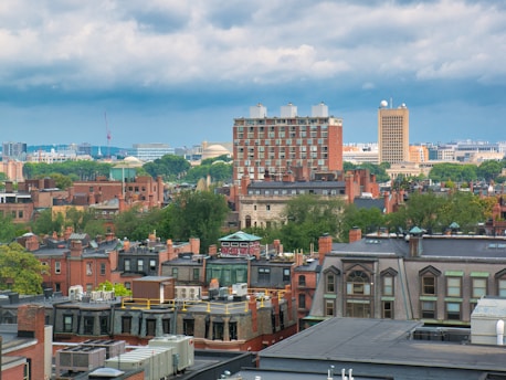 Massachusetts rooftops below cloudy sky