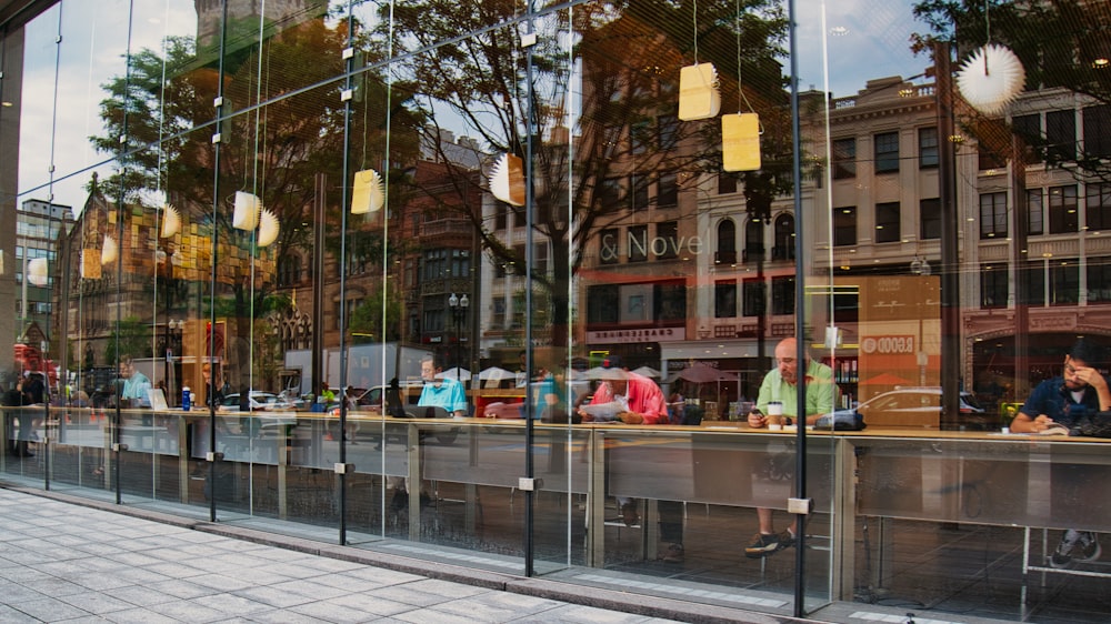 people sitting on bench near building during daytime