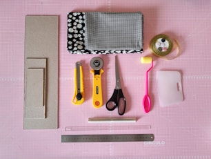red and yellow scissors beside black and white polka dot print pouch
