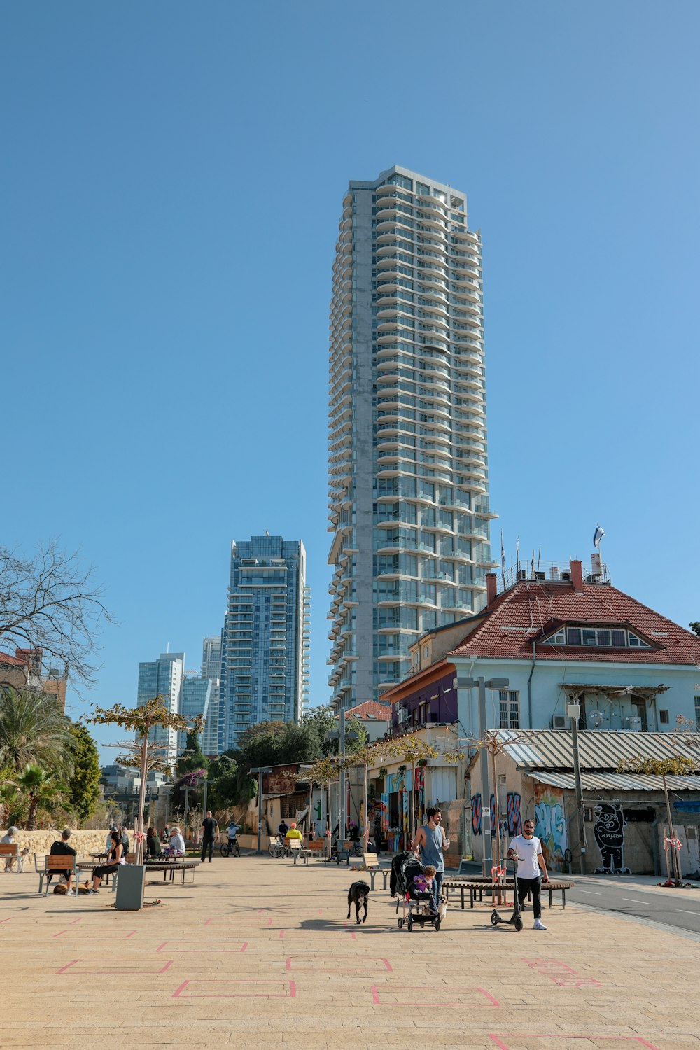 people walking on street near high rise buildings during daytime