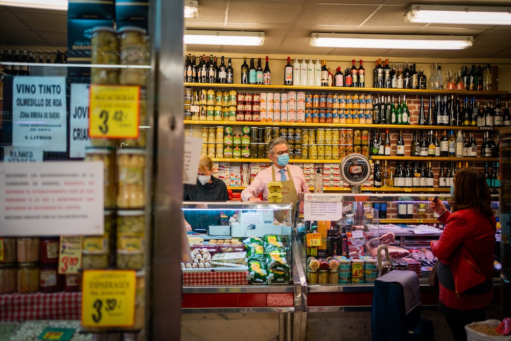 woman in pink polo shirt standing in front of store