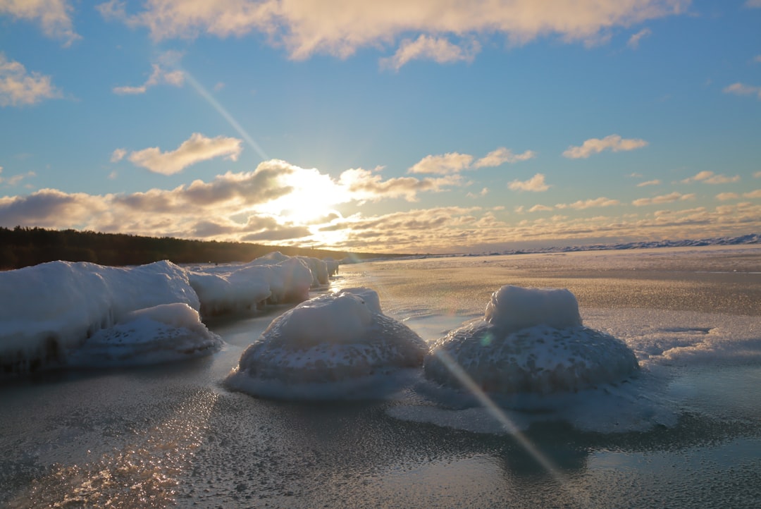 white ice on gray sand during daytime