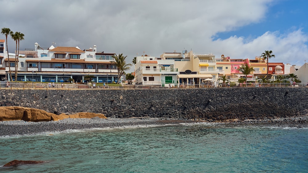 white and brown concrete buildings near body of water during daytime