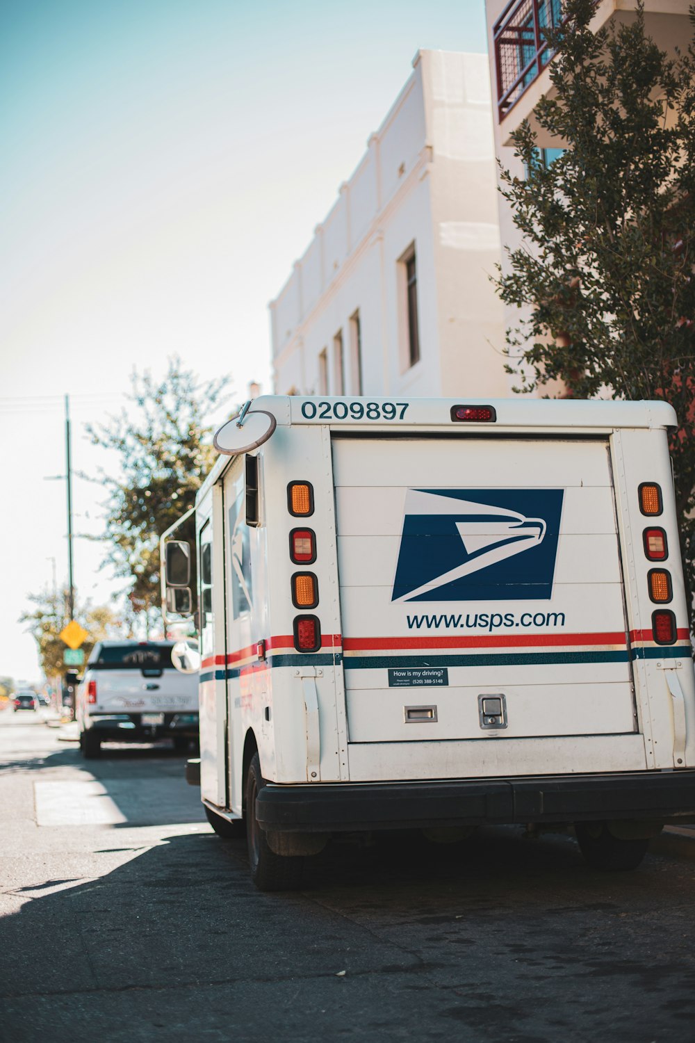 a mail truck parked on the side of the road