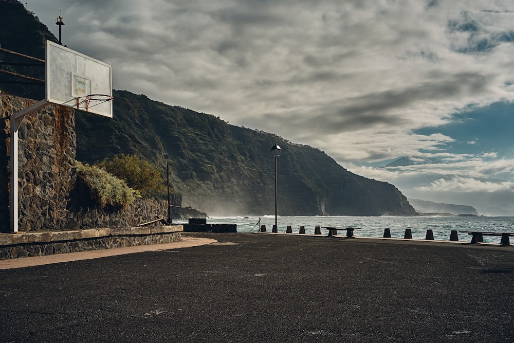 white and black concrete building near body of water under cloudy sky during daytime