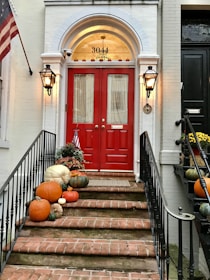 red wooden door on brown concrete staircase