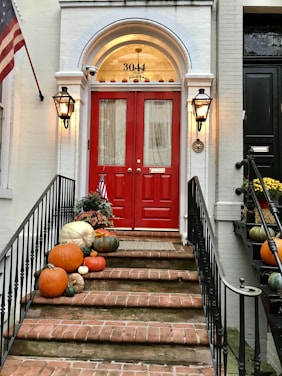 red wooden door on brown concrete staircase
