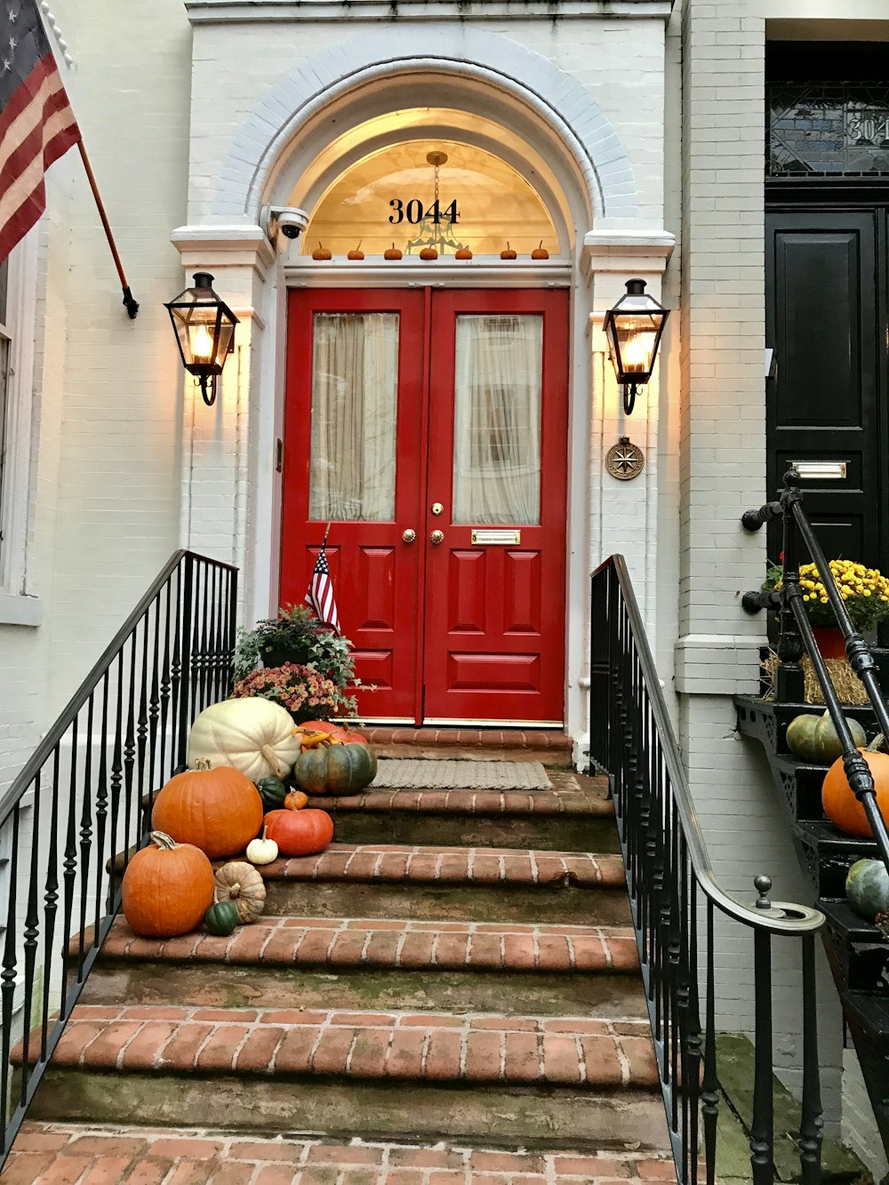 red wooden door on brown concrete staircase