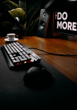 black and white computer keyboard on brown wooden table